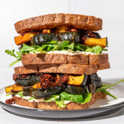 two squash sandwiches stacked on white and black plate
