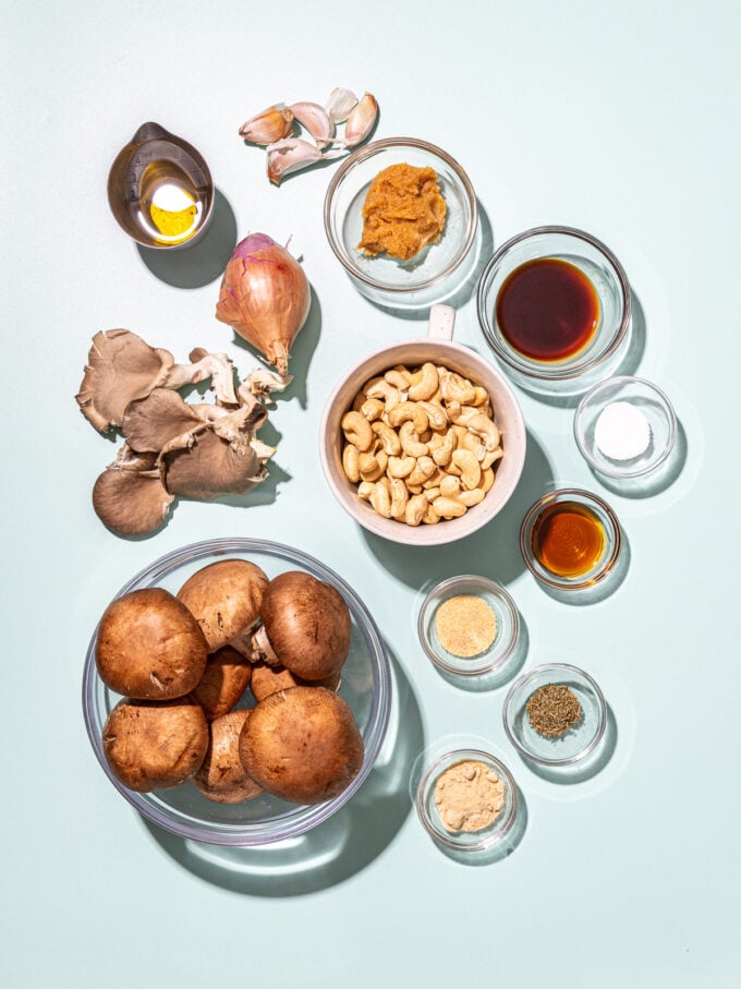 bowls of mushrooms, cashews, spices and shallot 